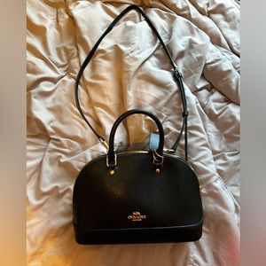Black coach purse with cross body strap.